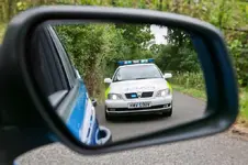 Police-car-in-mirror-jpg.webp